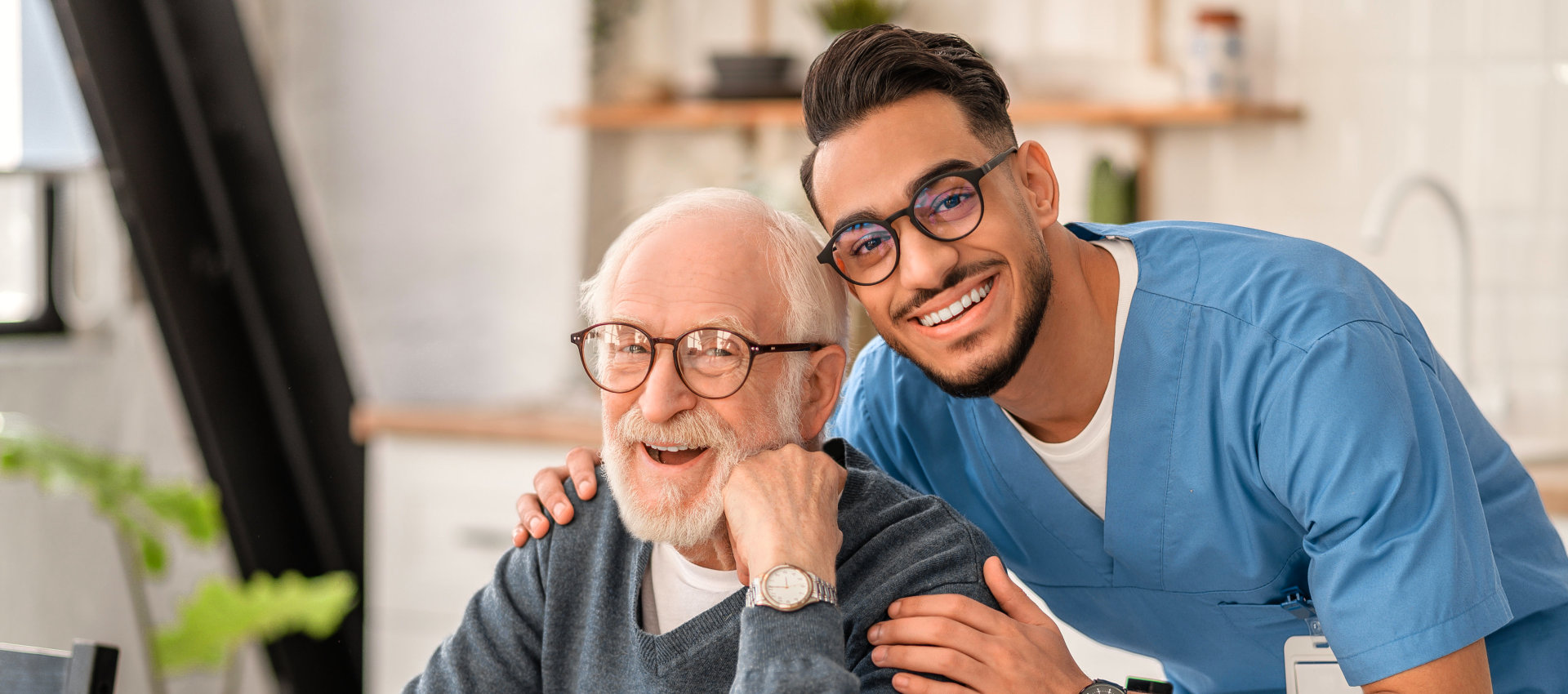 nurse hugging elderly man