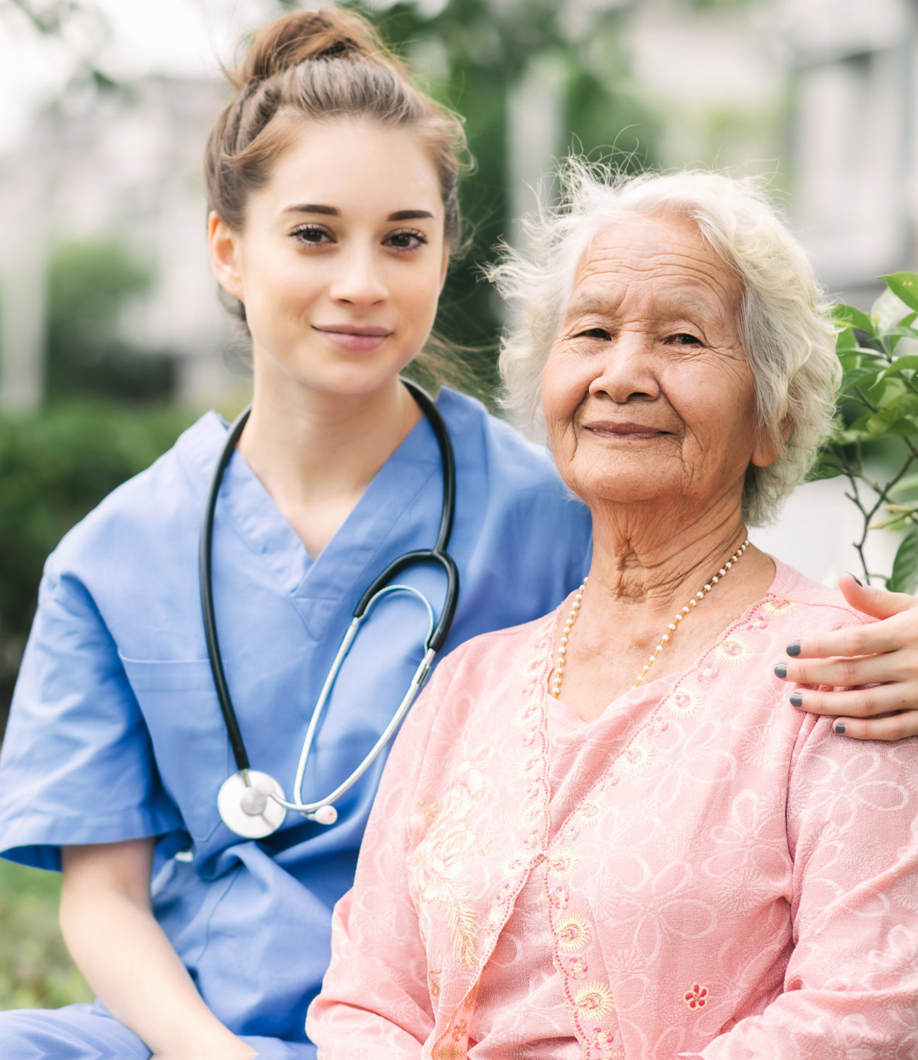 nurse and elderly woman sitting