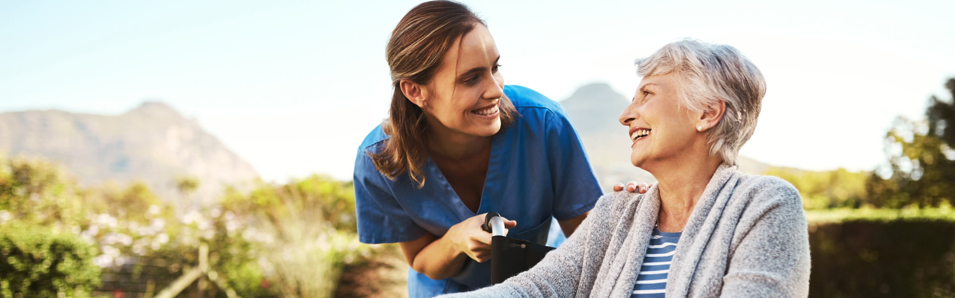 nurse assisting elderly woman