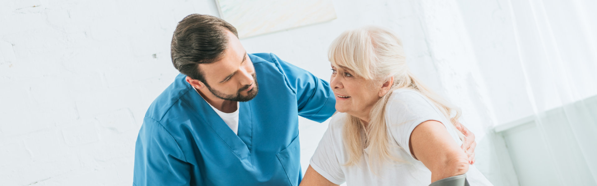 nurse assisting elderly woman