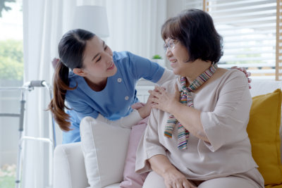 aide and elderly woman talking