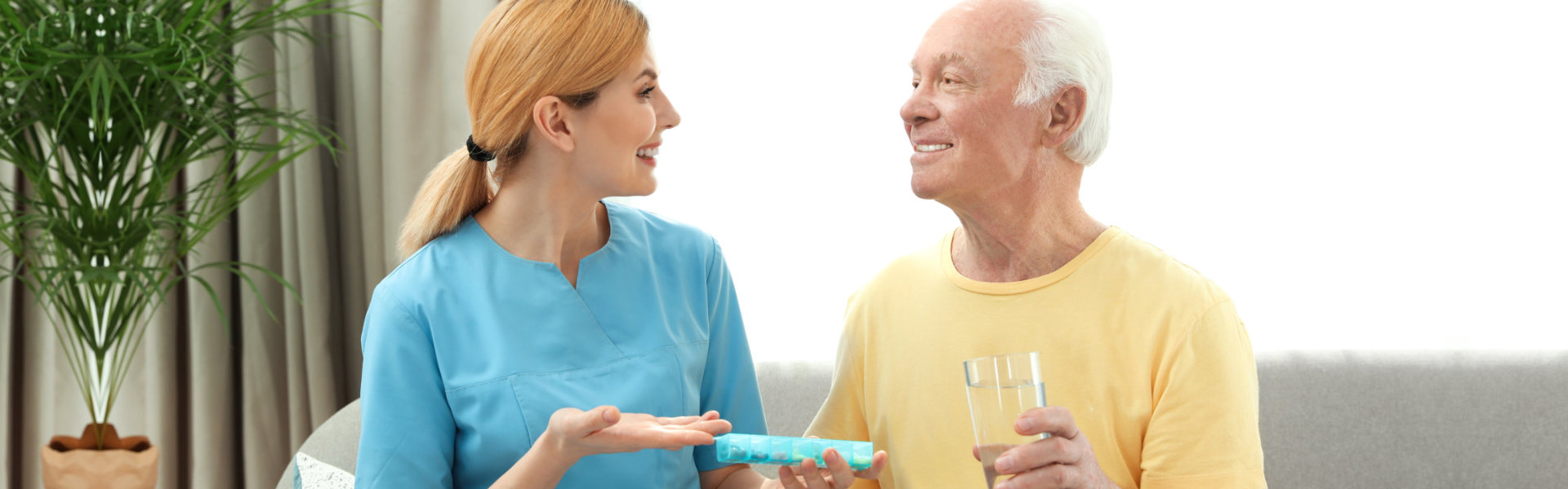 nurse giving medicine to elderly